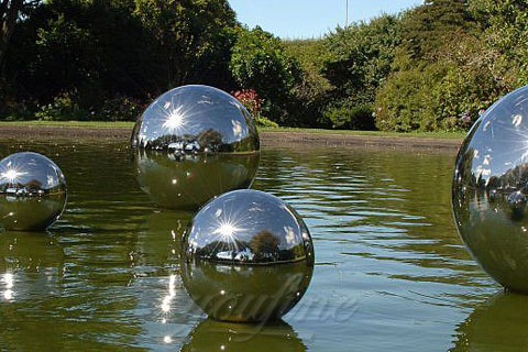 Mirror high polished shiny modern stainless steel sculpture on the river for sale